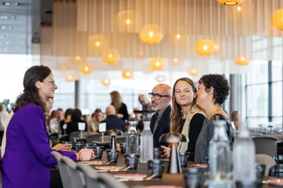A group of meeting guests sitting and talking at a table
