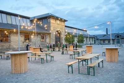 Øksnehallen seen from outside with festival tables and string lights