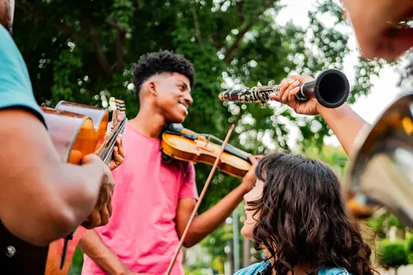 Young person playing violin outdoors