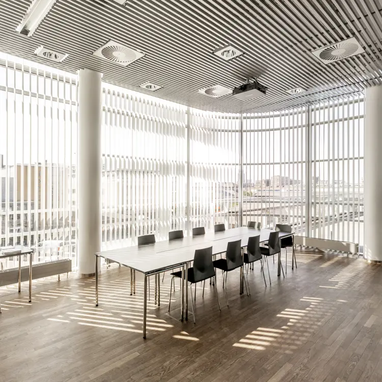 Et lyst mødelokale med en bordopsætning