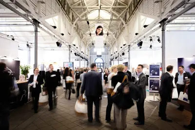 A lot of people walking around at a fair in Øksnehallen