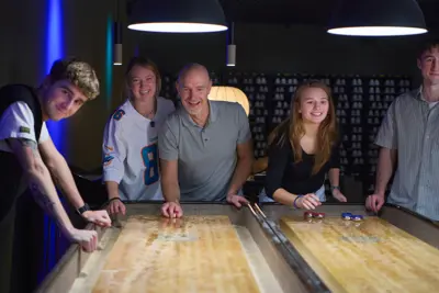 A group playing shuffleboard in DGI Byen
