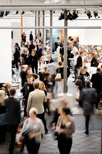 A group of people in Øksnehallen at a fair