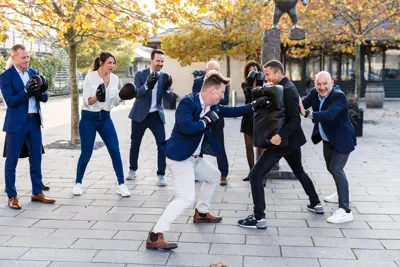 En gruppe kolleger der bokser og hepper udenfor