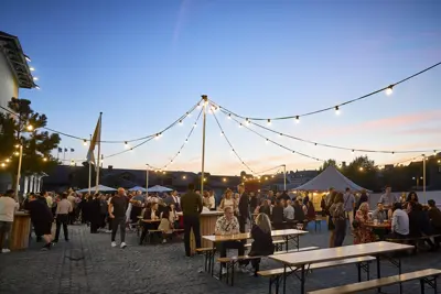 Øksnehallen exterior with festival tables and benches