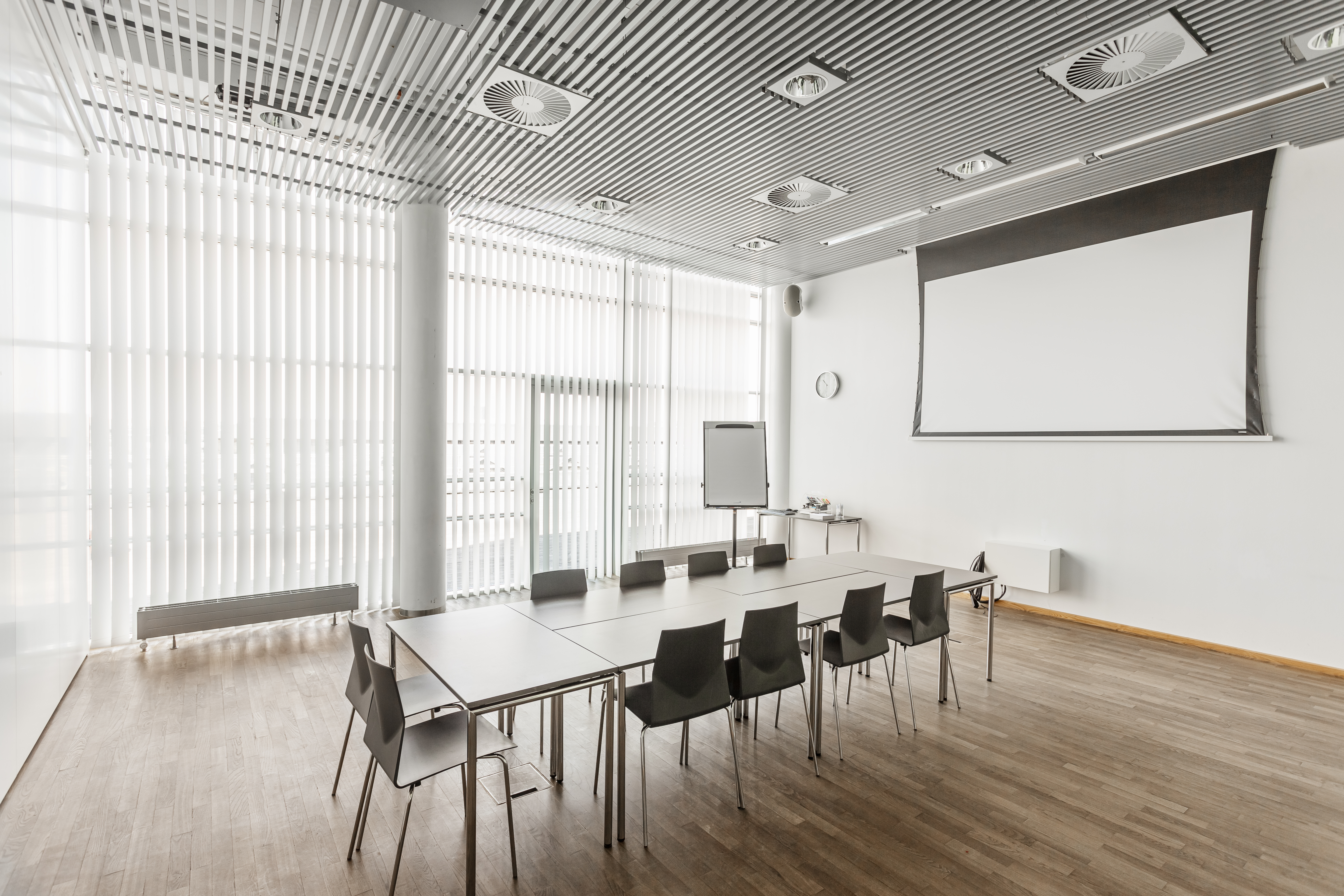 Et lyst mødelokale med en bordopsætning 